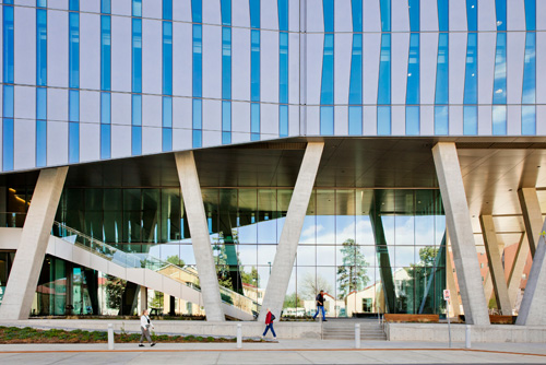 A photo of the modern, glass-walled main entranve of the Anschutz Health Sciences Building