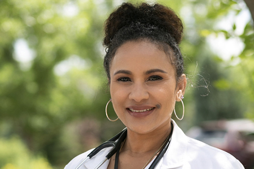 Salwa Bamba in white coat with stethoscope.