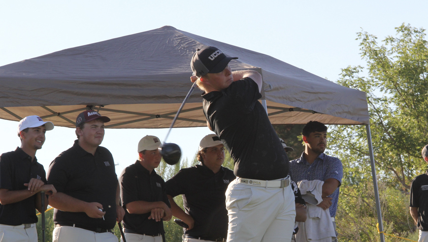 UCCS student swinging golf club