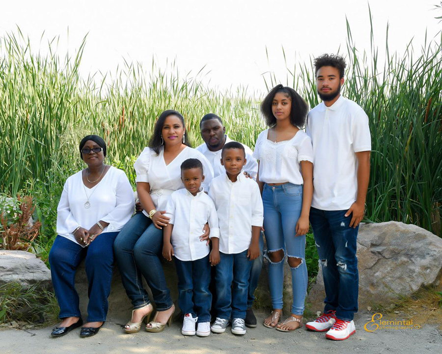 Salwa Bamba with family. They are wearing white shirts and blue jeans.