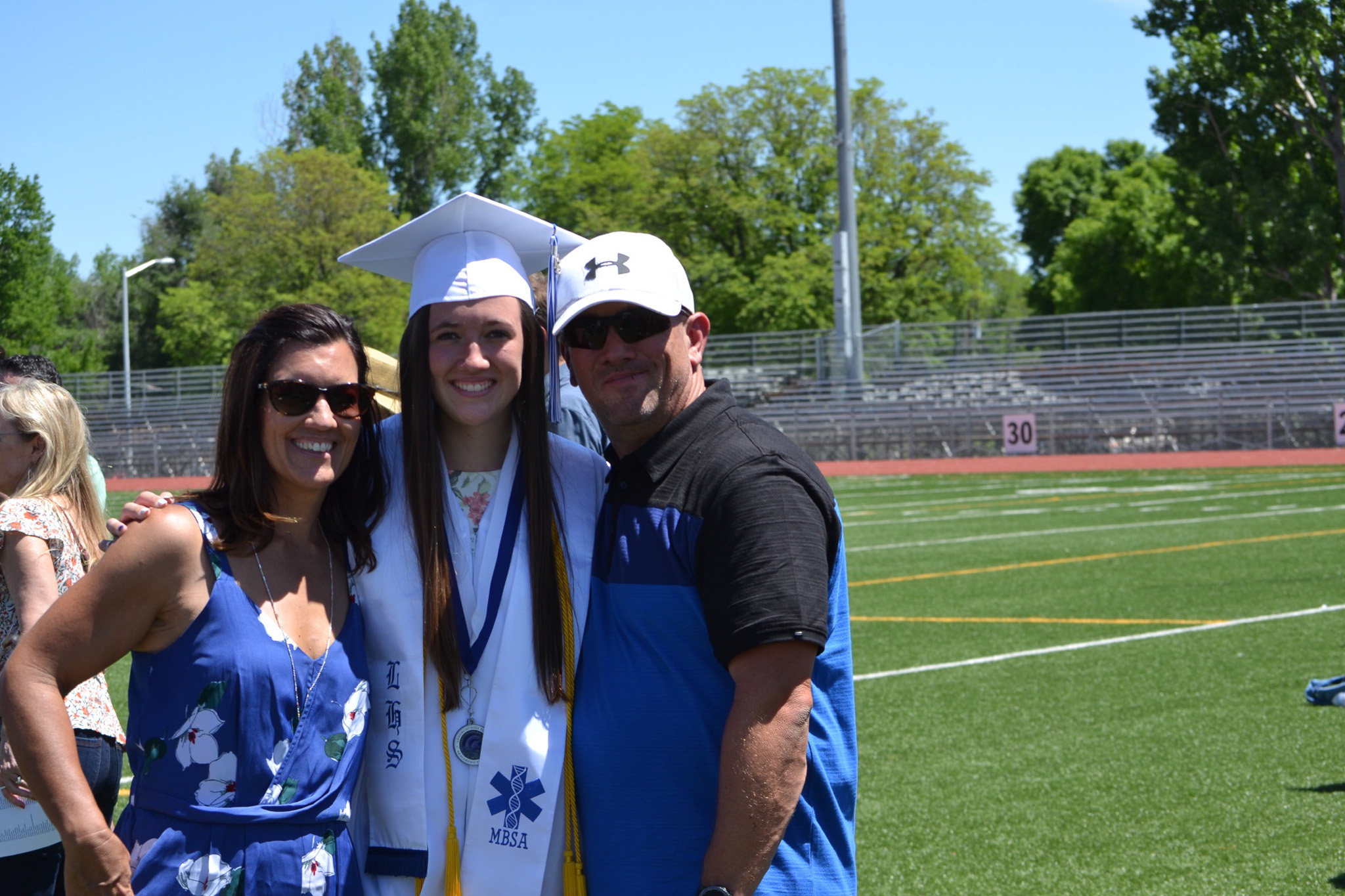 Kayla Waterman-Vandiver with her parents Jason and Katrina at her high school graduation.