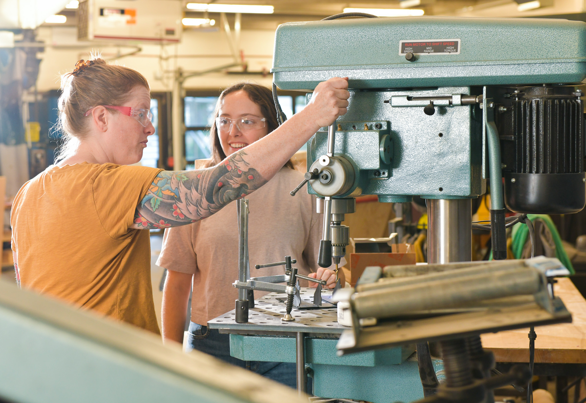 Workshop students Jasmine Jones and Caitlin Kennedy work on a drill press donated by the Dr. C.W. Bixler Family Foundation.